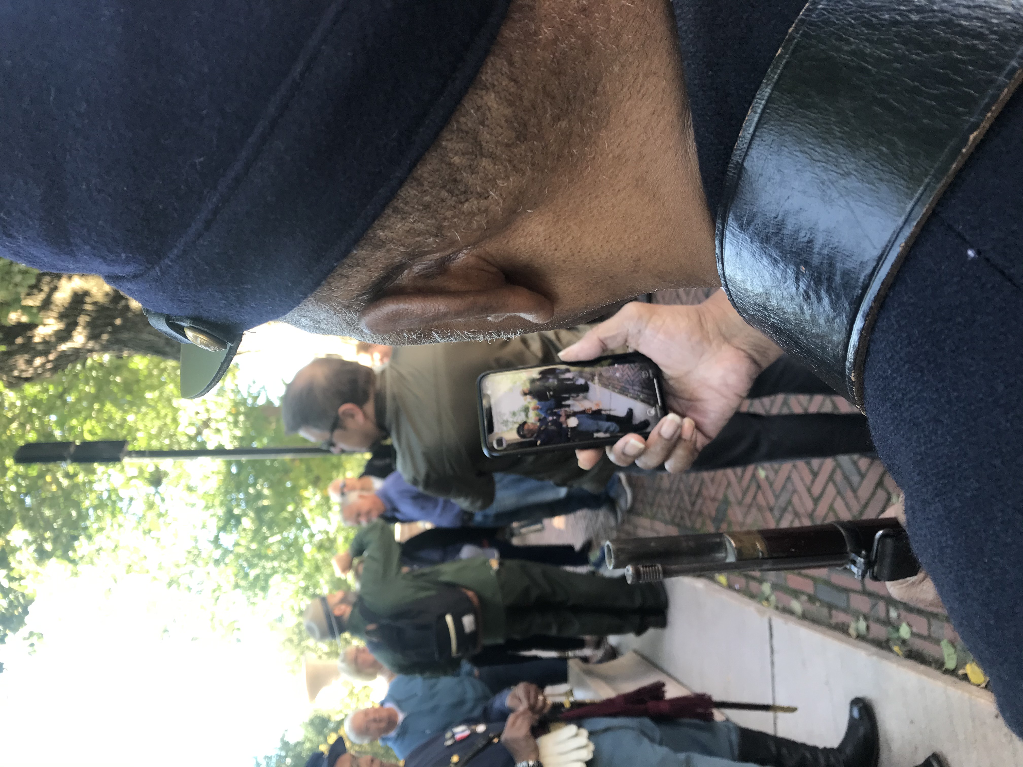 user at boston common ar exhibit watching a historian on their device