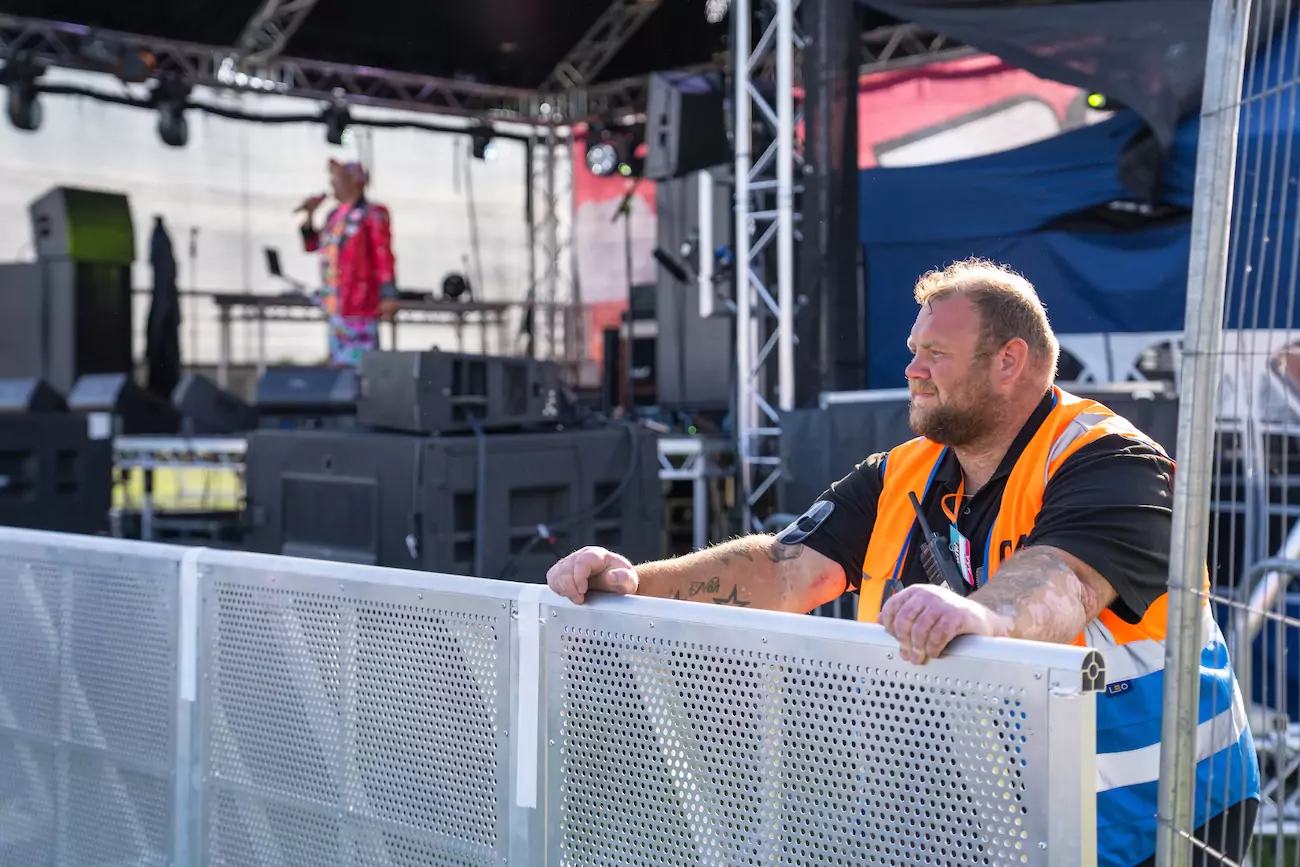 CR2 event security guard at the front of a festival stage monitoring the crowd. 