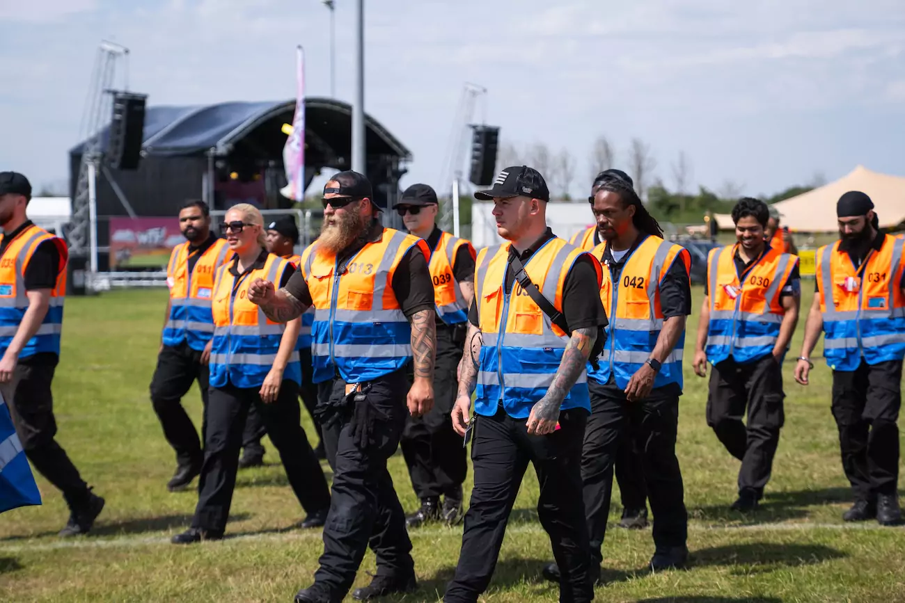 A group of CR2 security guards monitoring people at a festival site. 