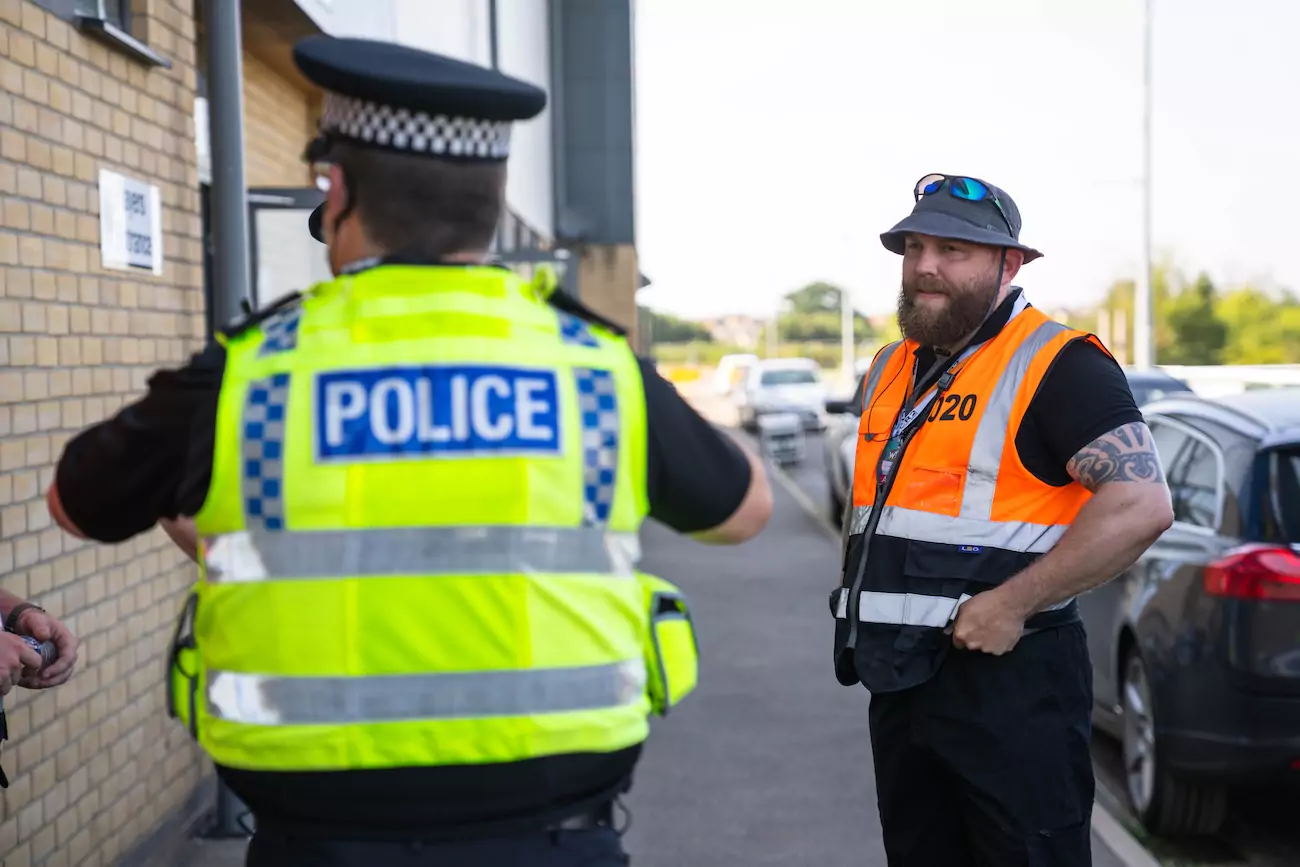 A CR2 security guard liaising with a police officer. 