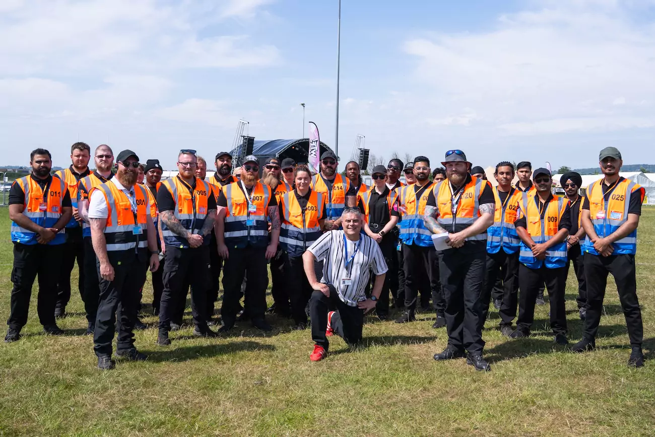 A photo of the security guards of CR2 Security company at a festival site. 