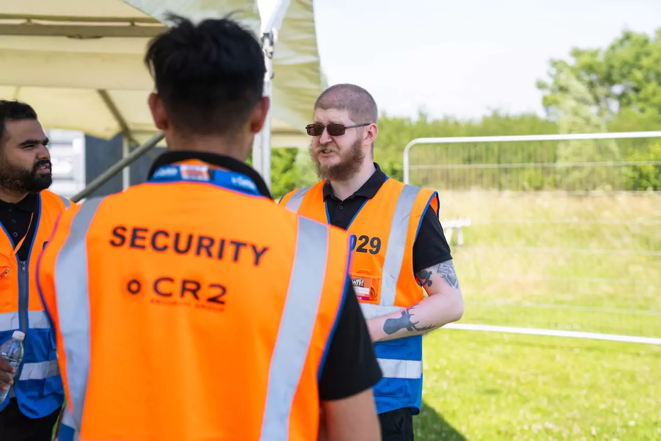 Two CR2 Security guards supervising a festival entry point. 
