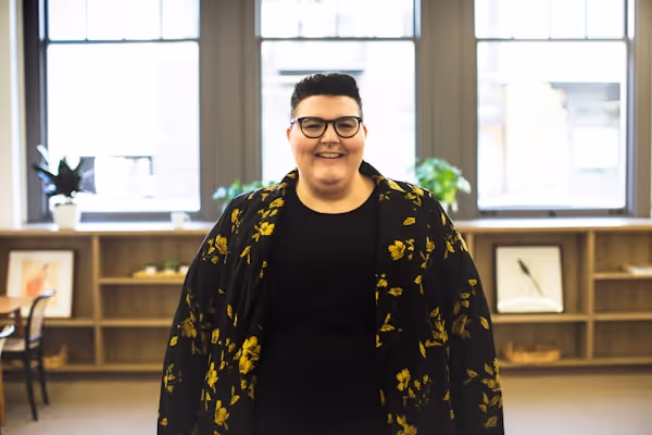 Plus size person at work in bright, open office workplace