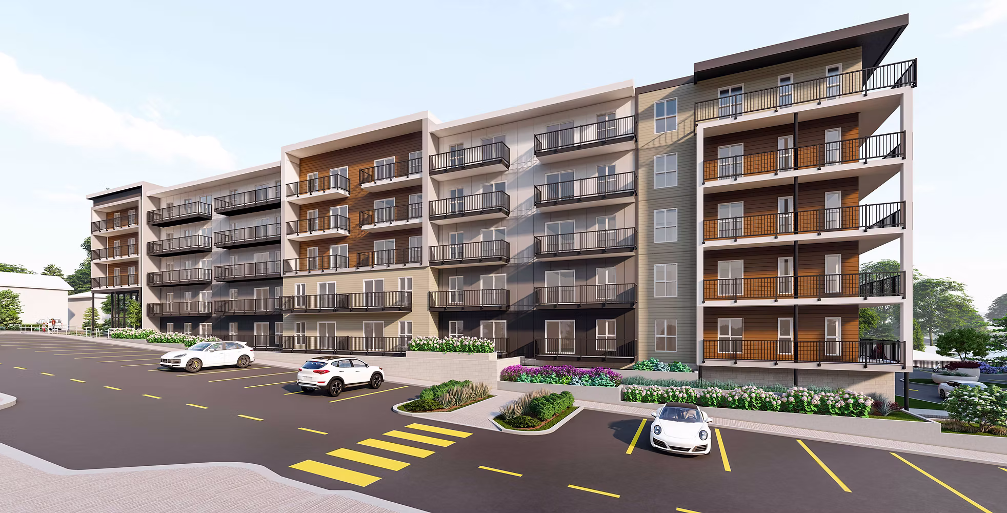 Modern multi-story apartment complex with parking lot and landscaped grounds