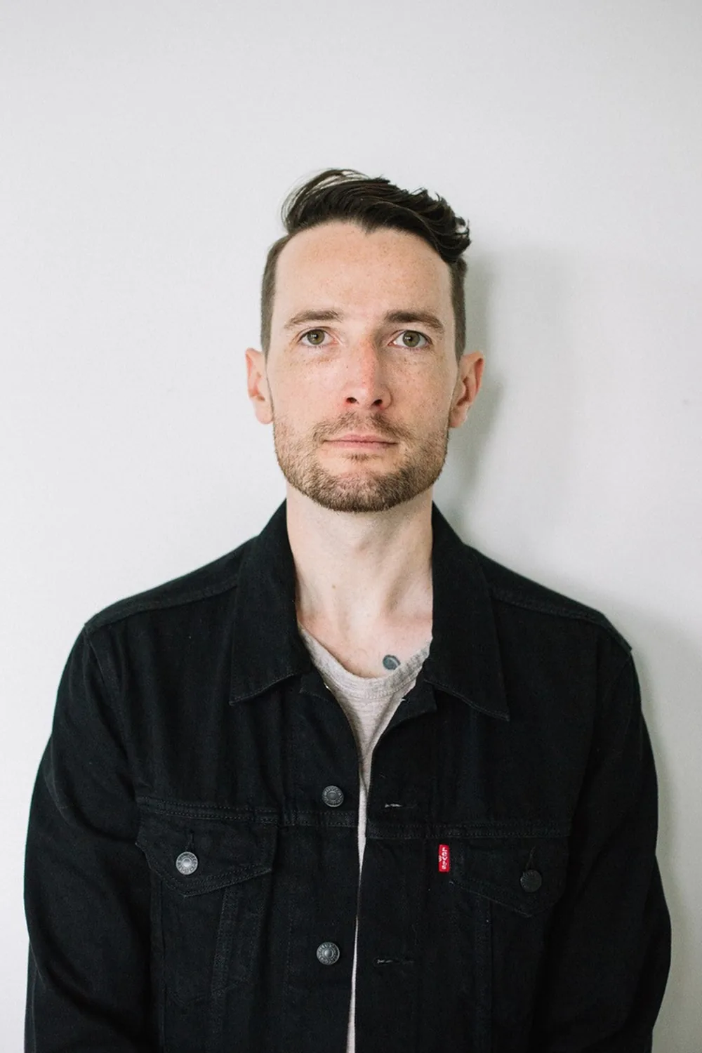 Design professional in black jacket showcasing Engineering Works portfolio