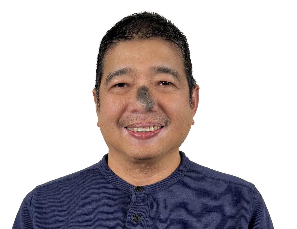 Professional portrait of smiling man in blue shirt, Design Works Engineering team member