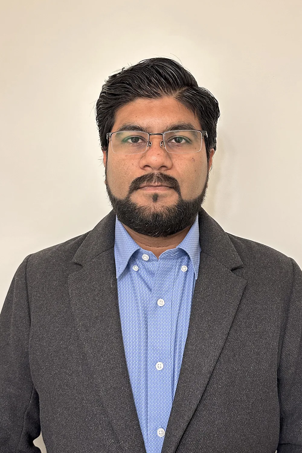 Professional portrait of engineer in Design Works Engineering sector wearing glasses and business attire