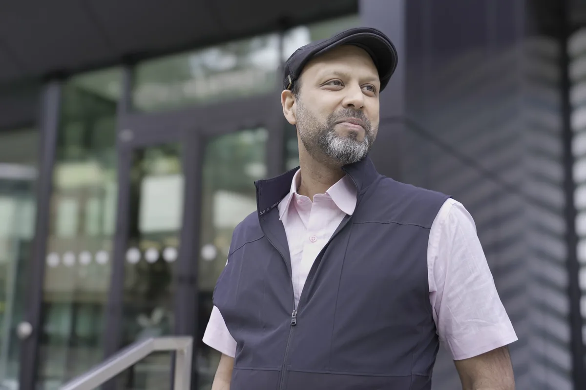 Professional man in Design, Works, Engineering project, standing outside modern building entrance