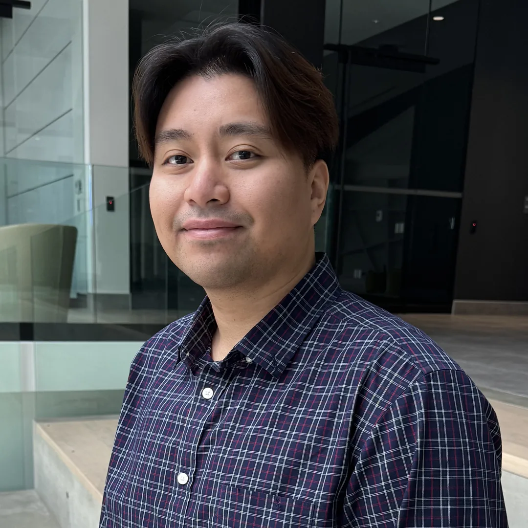 Professional in plaid shirt. Design, Works, Engineering in modern office setting.