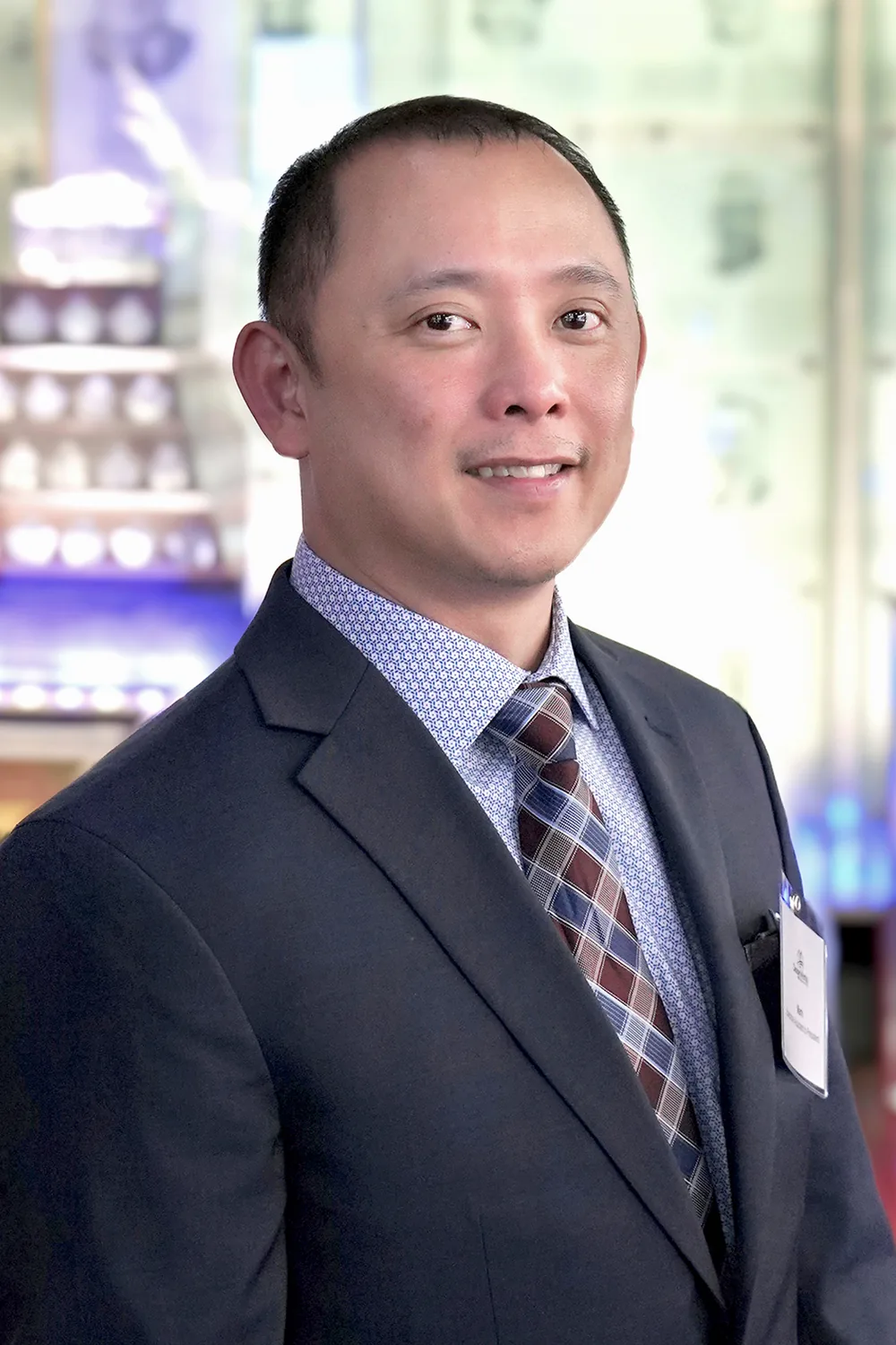 Professional portrait of man in suit; Design, Works, Engineering conference background