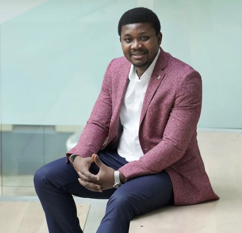 Professional man in burgundy blazer demonstrates successful Design, Works, and Engineering solutions.