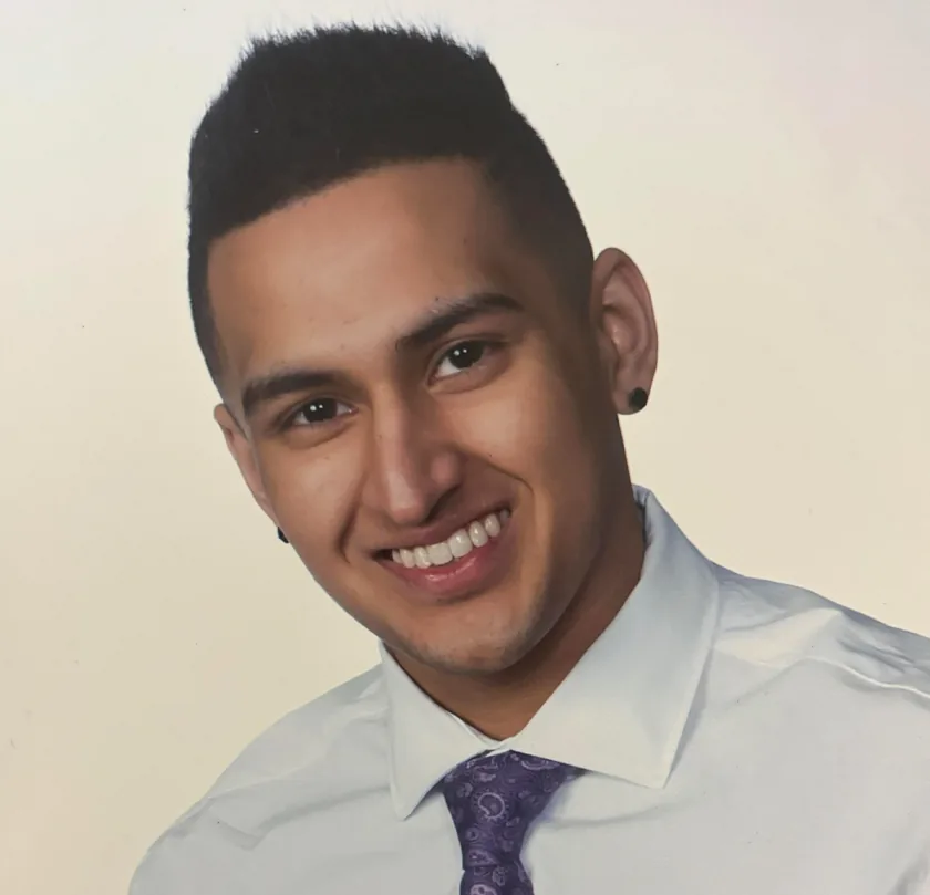 Design engineer smiling in white shirt, professional portrait showing engineering and design expertise at works