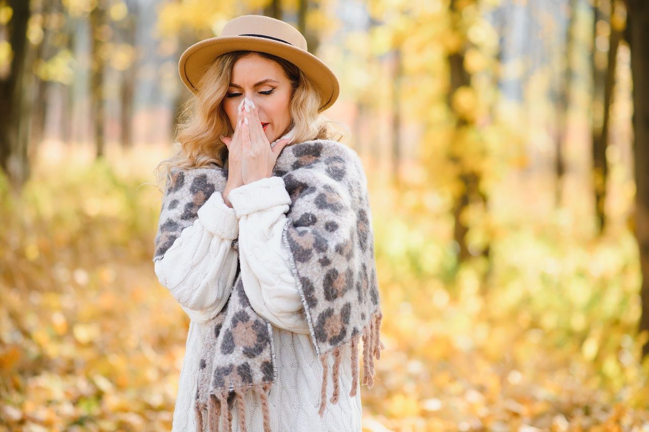 woman sneezing with fall allergies