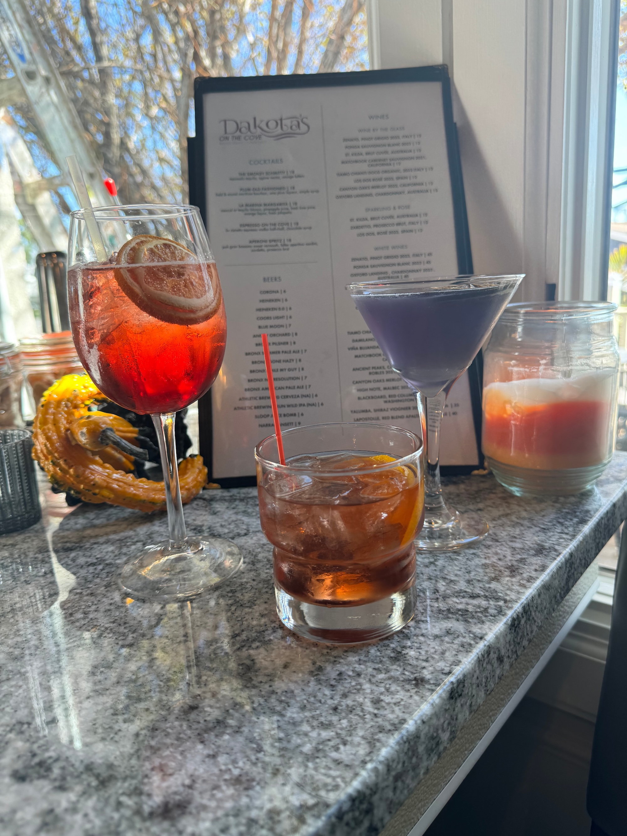 Three drinks situated in front of menu