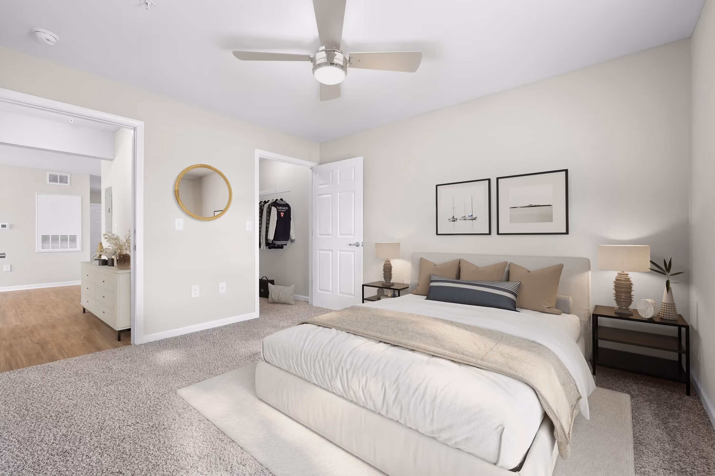 Spacious bedroom in an apartment at The Grand at Lake Sheri, Valdosta, GA, with carpet flooring, a ceiling fan, and an en-suite bathroom entrance.