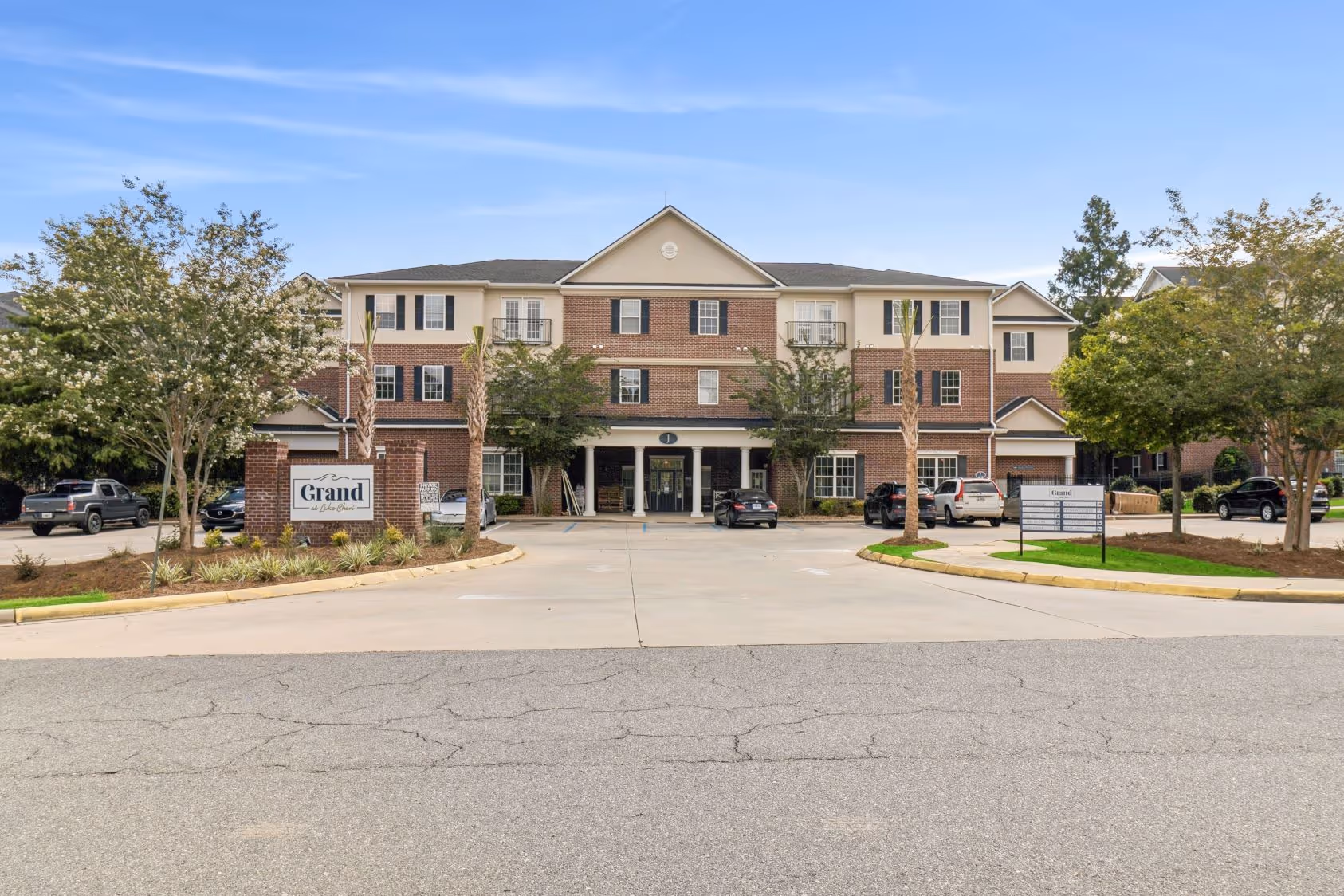 Outdoor sand volleyball court under a clear blue sky at The Grand at Lake Sheri in Valdosta, GA, perfect for resident recreation.