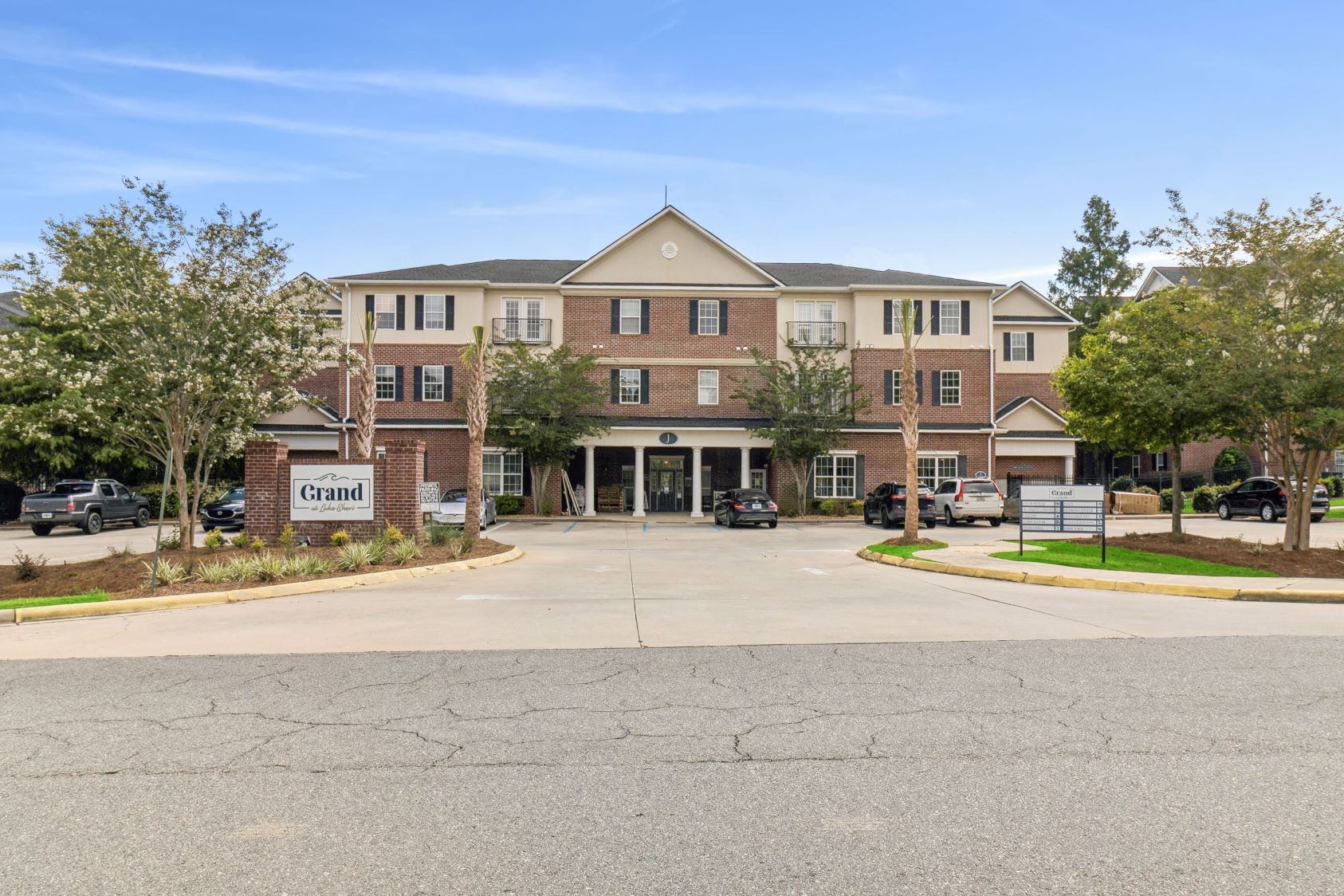 Outdoor sand volleyball court under a clear blue sky at The Grand at Lake Sheri in Valdosta, GA, perfect for resident recreation.