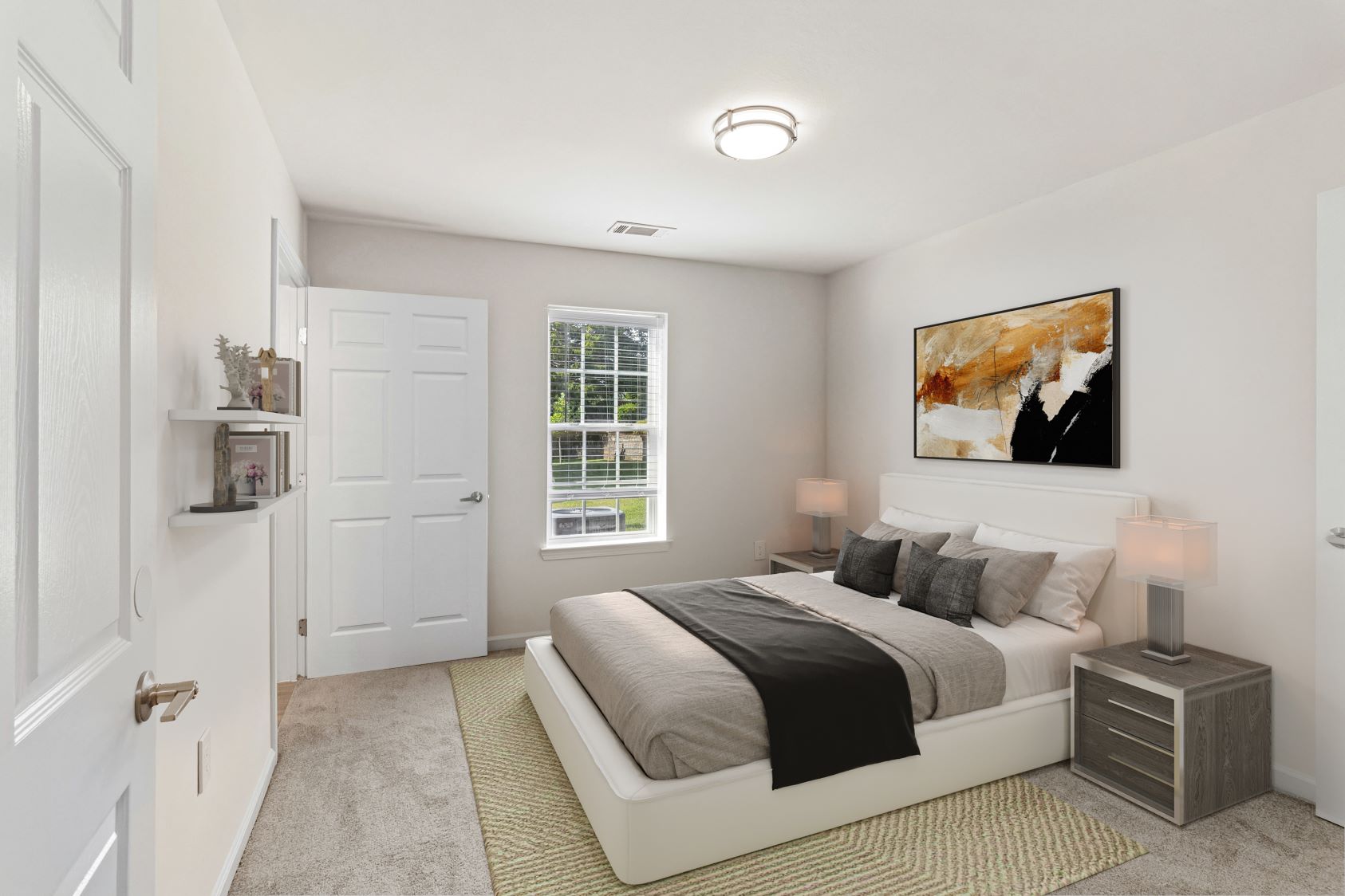 Spacious bedroom in an apartment at The Grand at Lake Sheri, Valdosta, GA, with carpet flooring, a ceiling fan, and an en-suite bathroom entrance.