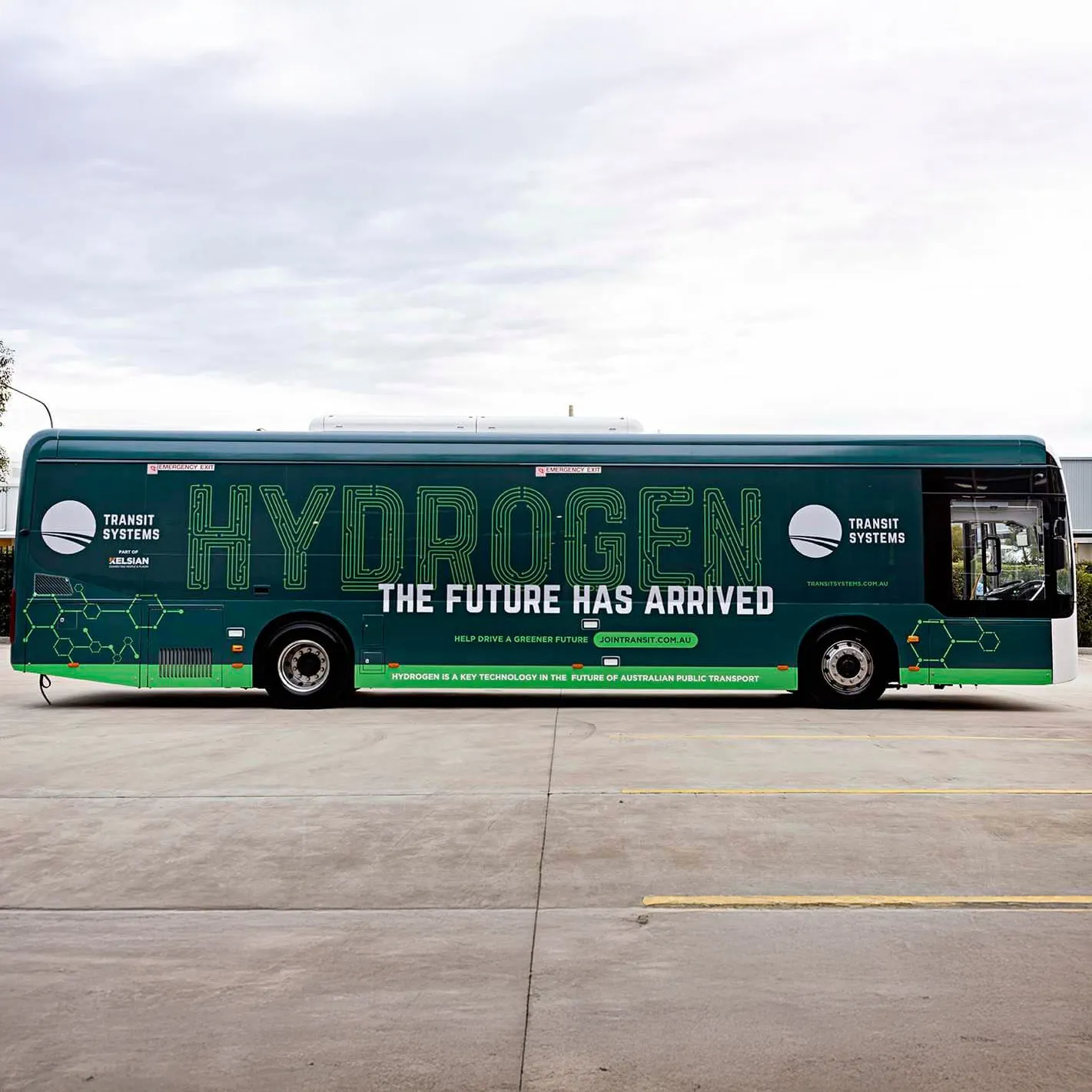 A green Transit Systems bus with bold text reading "HYDROGEN - THE FUTURE HAS ARRIVED" displayed on its side, promoting hydrogen as a key technology for greener public transport.