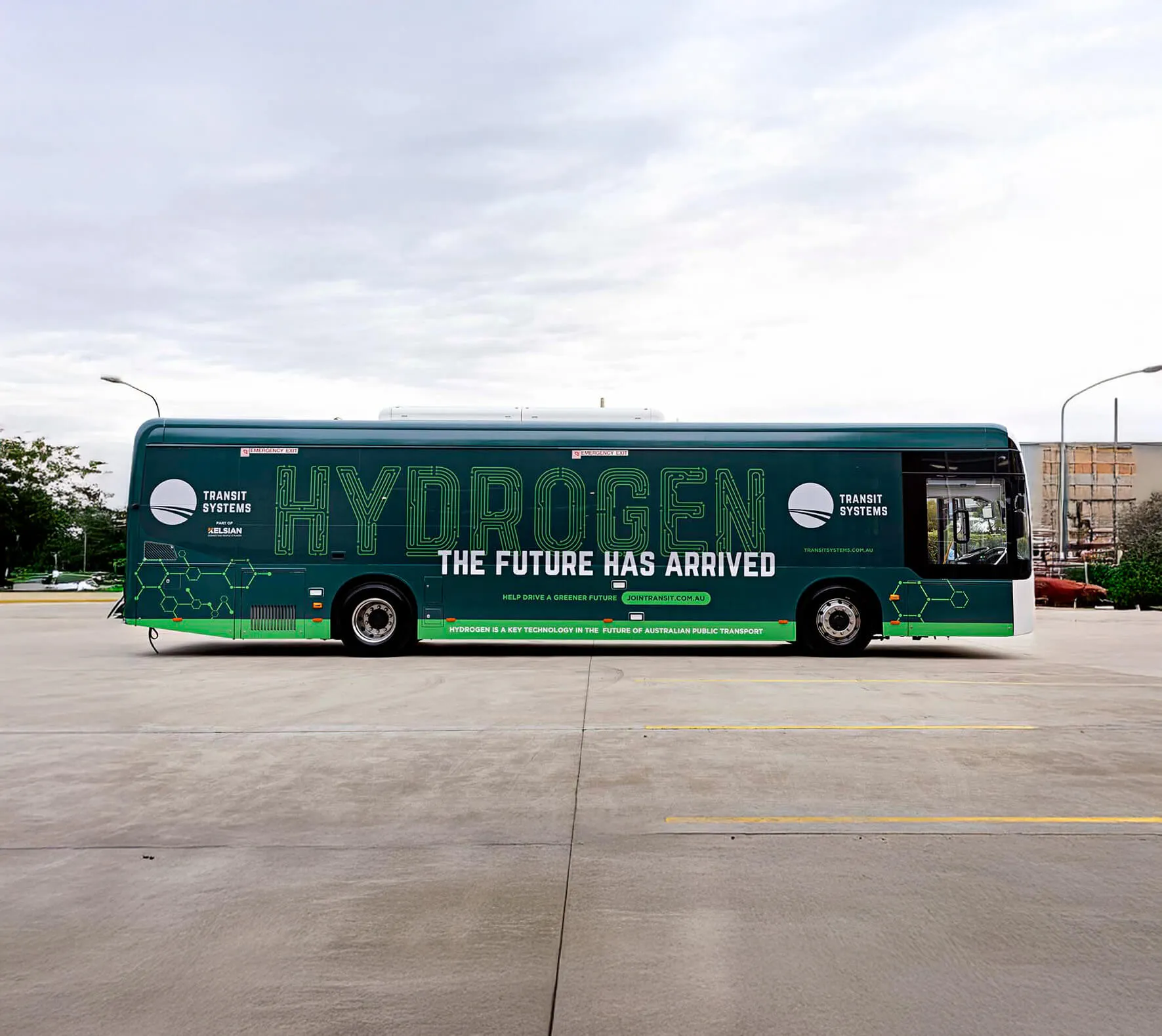 A green Transit Systems bus with bold text reading "HYDROGEN - THE FUTURE HAS ARRIVED" displayed on its side, promoting hydrogen as a key technology for greener public transport.