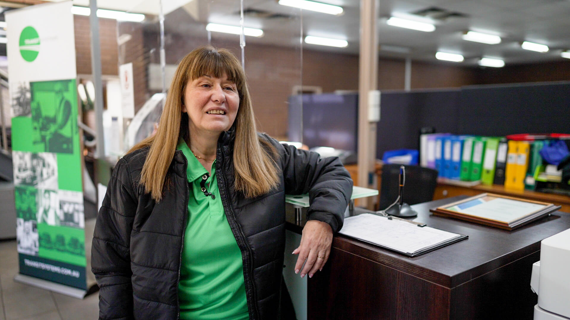 A person standing next to a desk