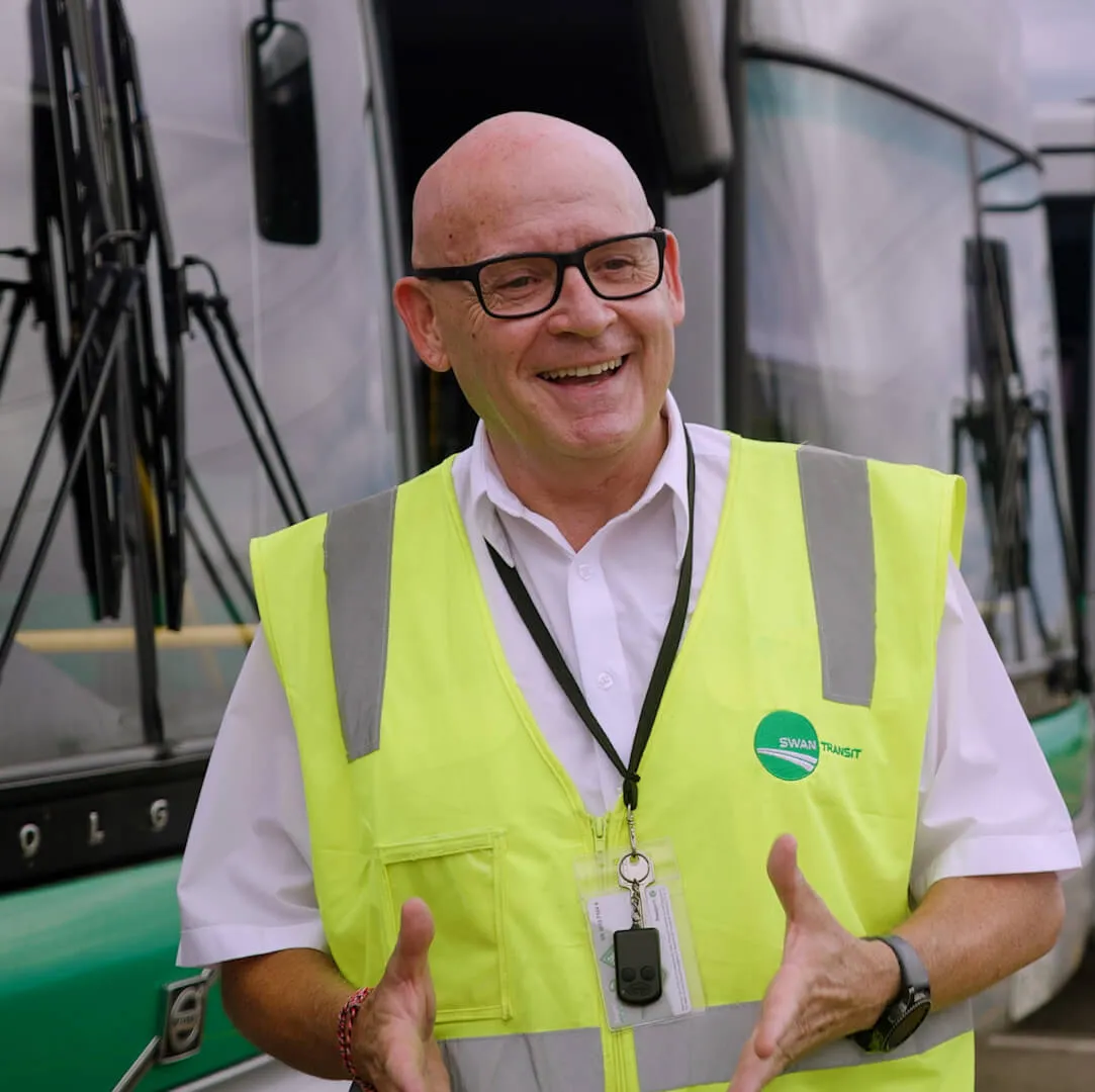 A person wearing a yellow vest and glasses