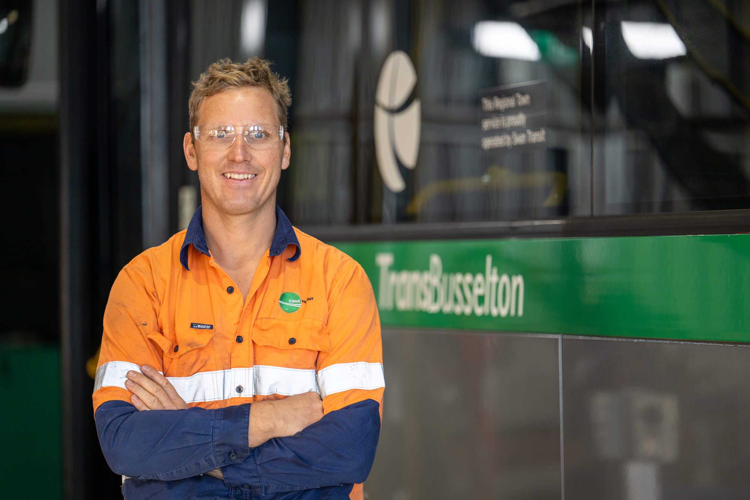 A Transit System Mechanic in front of a Bus.