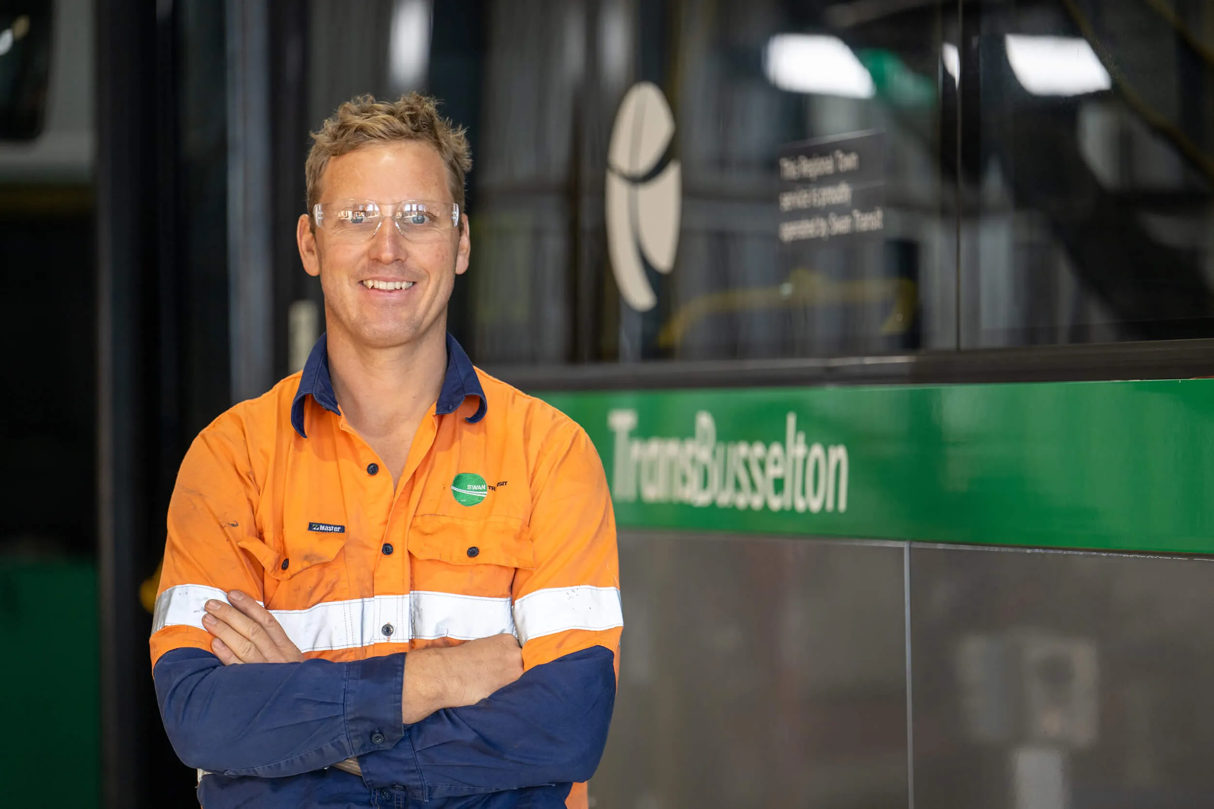 A Transit System Mechanic in front of a Bus.