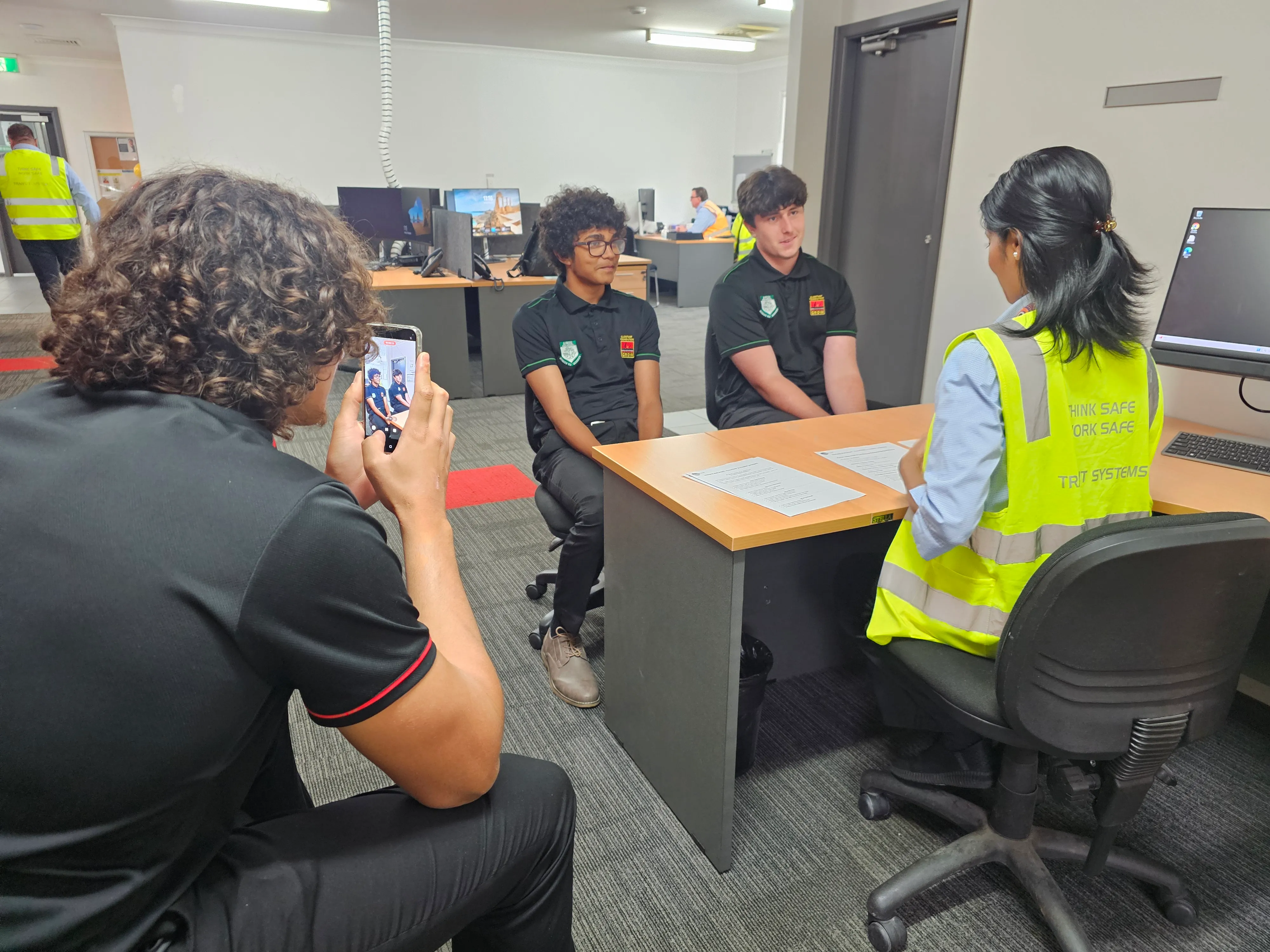 Students participating in mock interviews at a desk