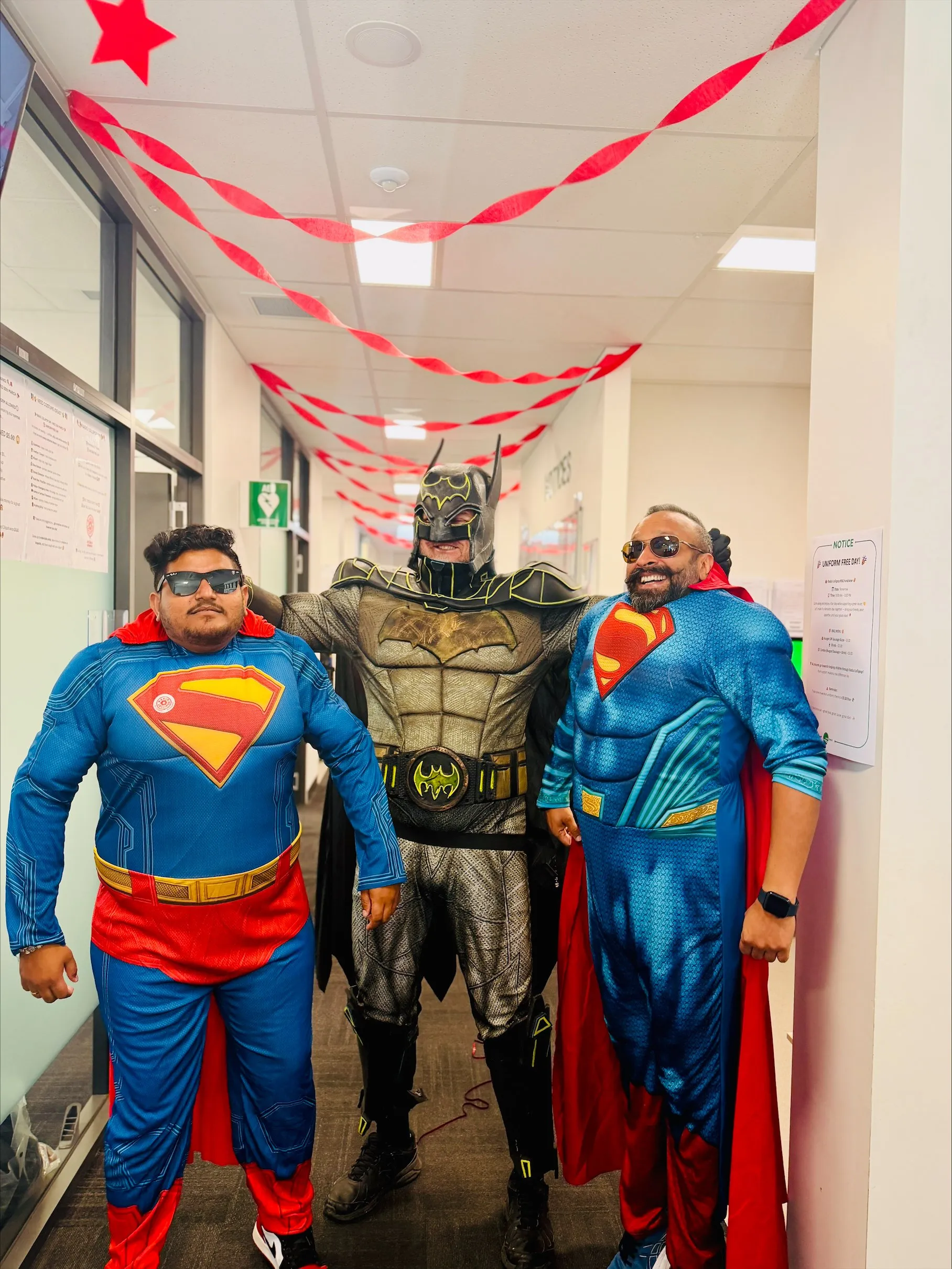three men in superhero costumes