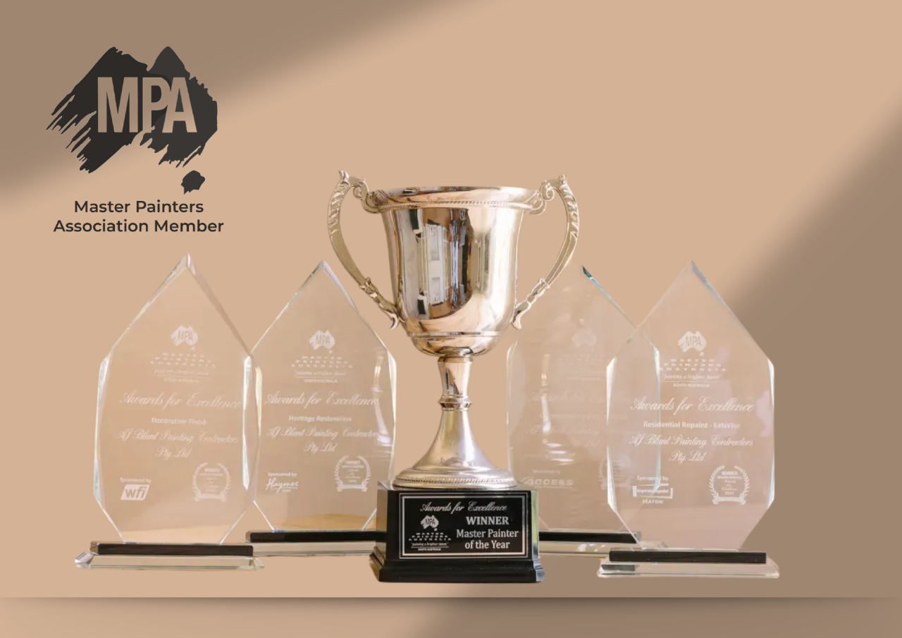 Master Painter of the Year trophy and four Awards for Excellence on a wooden table.