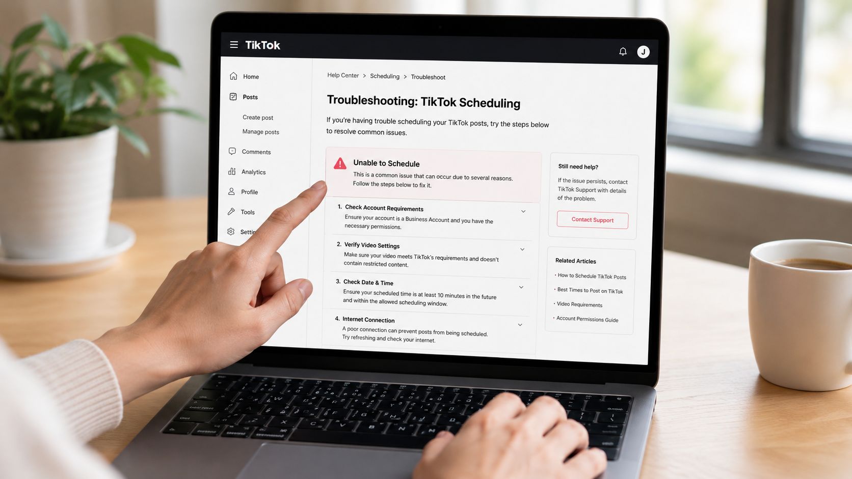 A person using a laptop to read a TikTok help center troubleshooting guide for scheduling posts.