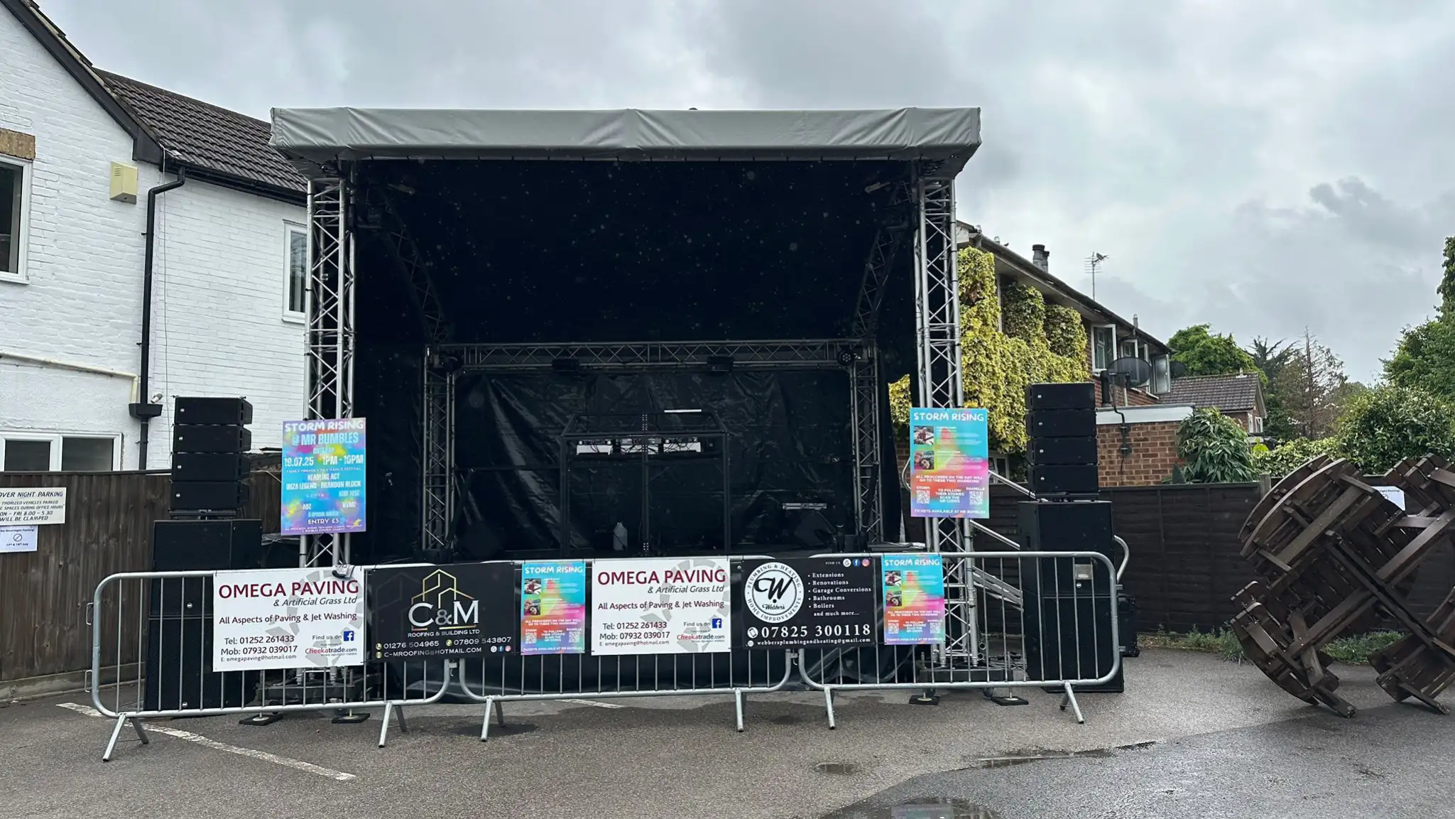 Covered event stage installed on an outdoor grass site