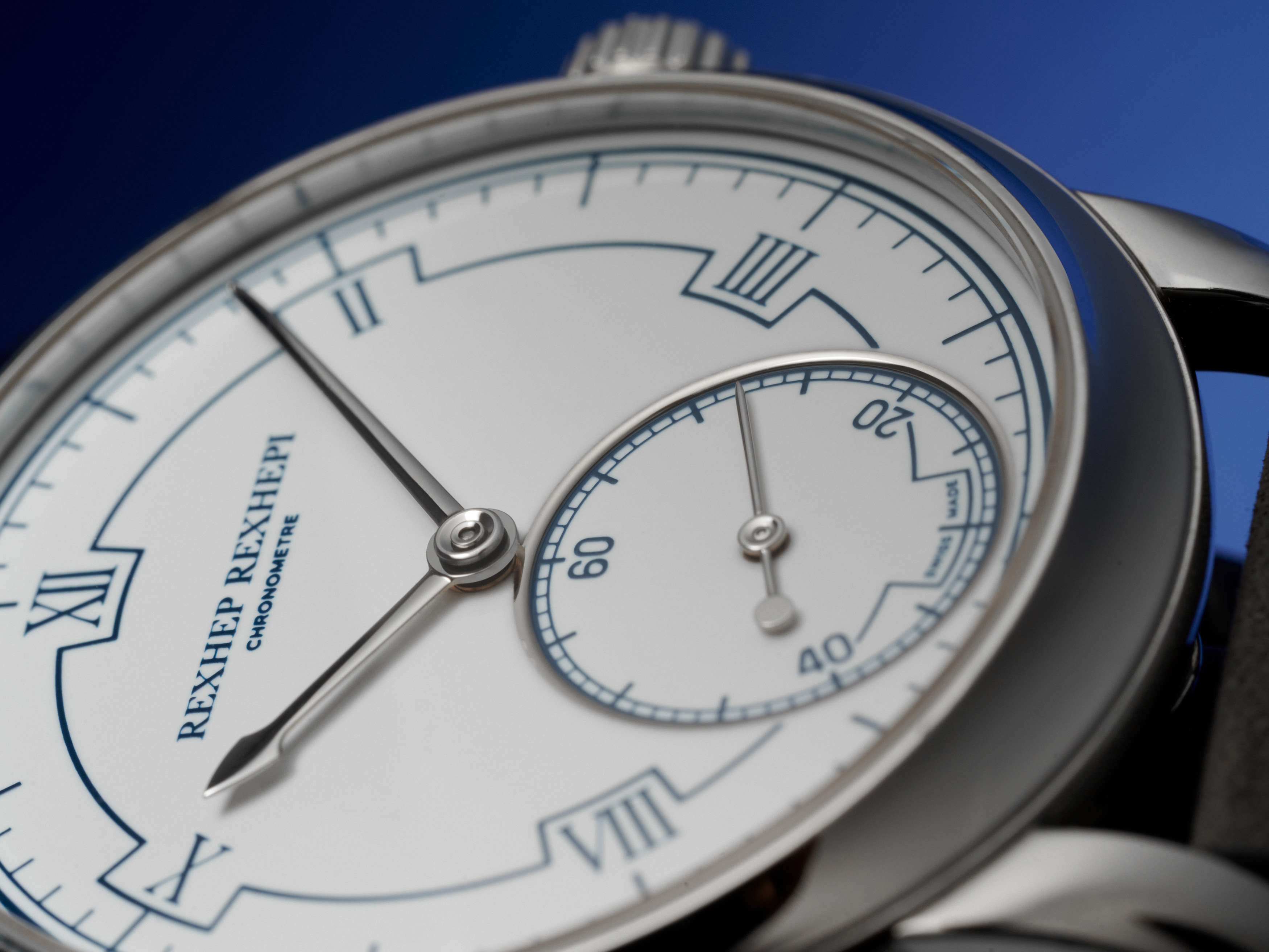 Close-up of the white Grand Feu enamel dial and the blue alternating sector around the Roman numerals of the RRCC I