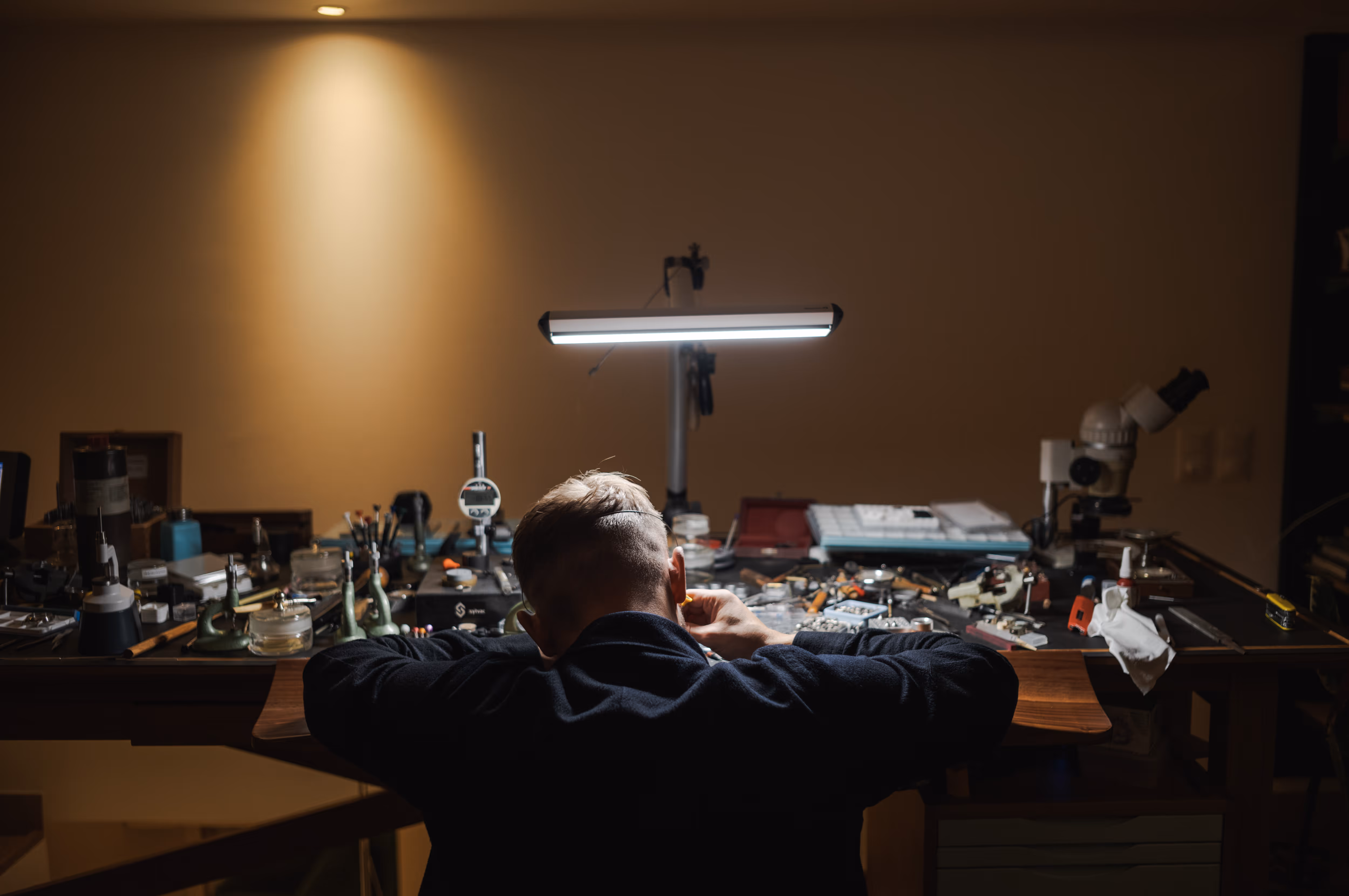 Watchmaker Rexhep Rexhepi working by night at his bench in his Old Town Geneva atelier