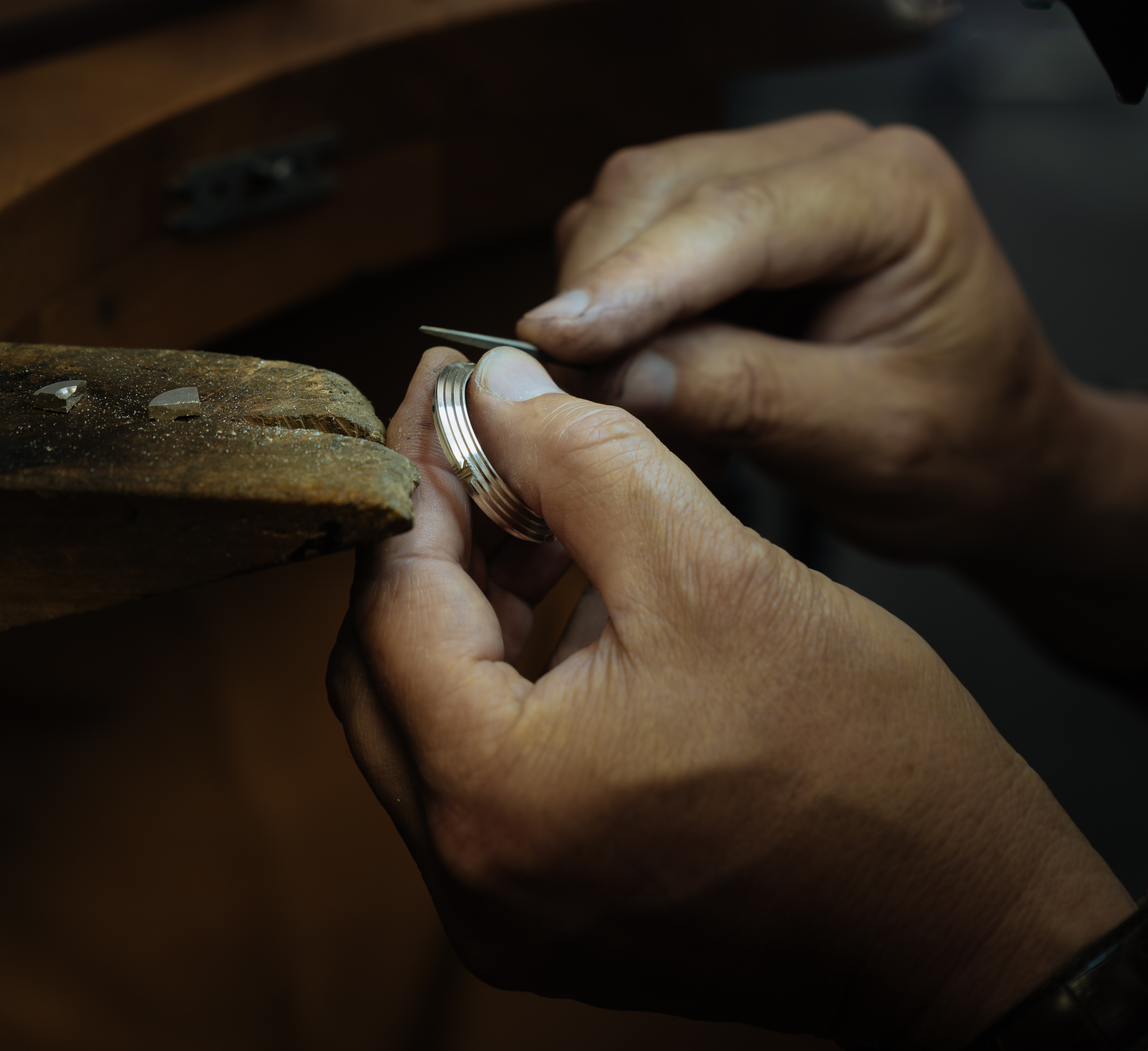 Close-up of an artisan hand-filing the RRCC II watch case