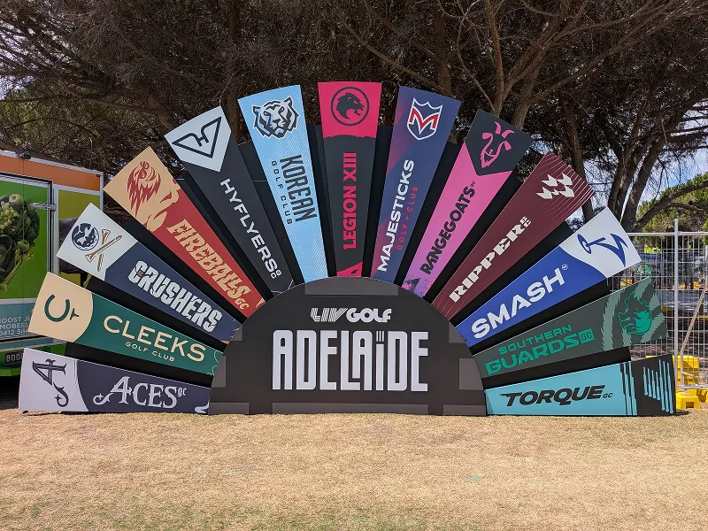 Colorful fan-shaped display with logos of various golf clubs around Adelaide, including Aces, Cleeks, Crushers, Fireballs, Hyflyers, Korean GC, Legion XII, Majesticks, Rangeoats, Rippers, Smash, Southern Guards, and Torque.