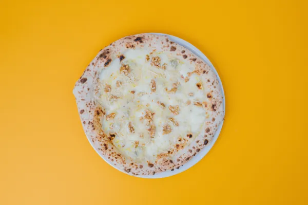 Neapolitan Fourmaggi pizza - a four-cheese white pizza with mozzarella, scamorza, gorgonzola, Grana Padano and walnuts.