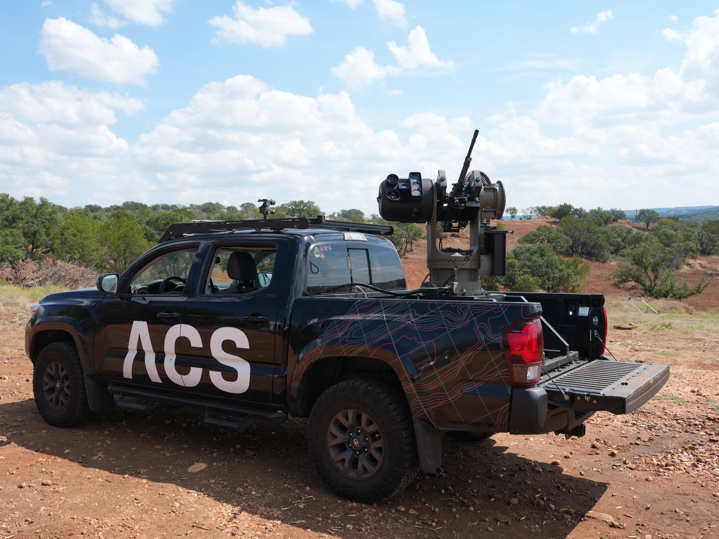 ACS Bullfrog autonomous counter-UAS weapon station mounted on an ACS pickup truck in the field