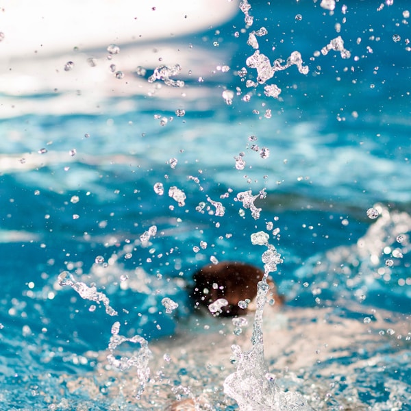 A kid diving at the swimming pool