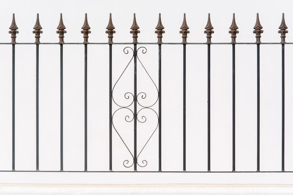 Ornamental steel fence with decorative finials and a clean black finish Ornamental steel fence with decorative finials and a clean black finish