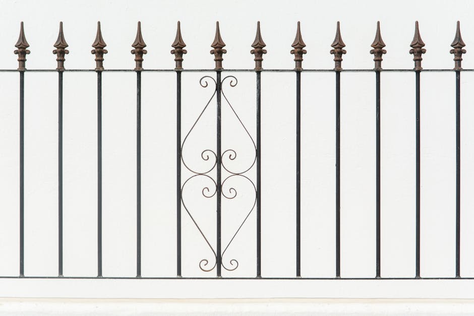 Ornamental steel fence with decorative finials and a clean black finish