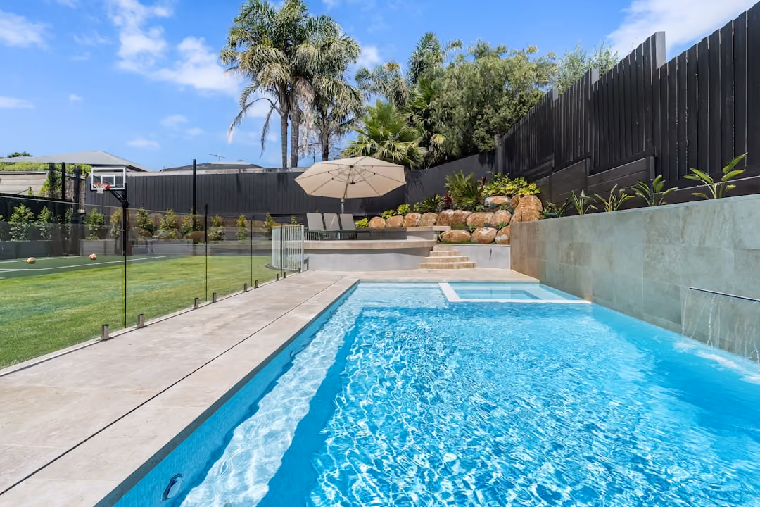 Professional MA pool fence contractor installing a classic black aluminum fence around a backyard pool Professional MA pool fence contractor installing a classic black aluminum fence around a backyard pool