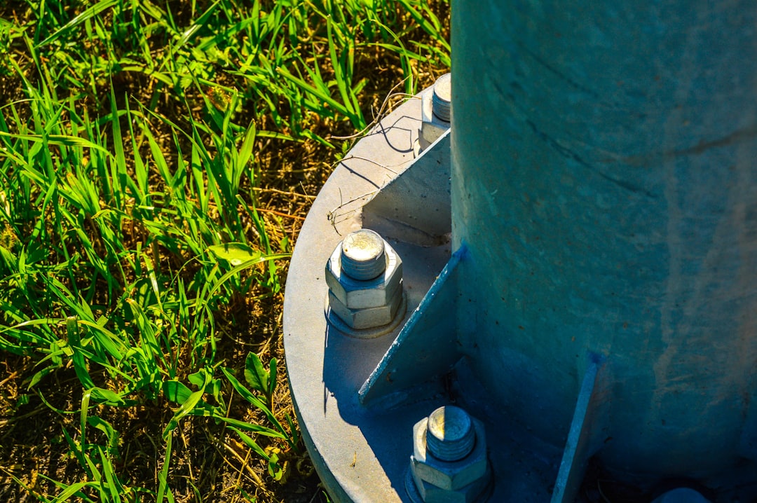 galvanized base plate with heavy duty anchor bolts secured to a concrete slab galvanized base plate with heavy duty anchor bolts secured to a concrete slab