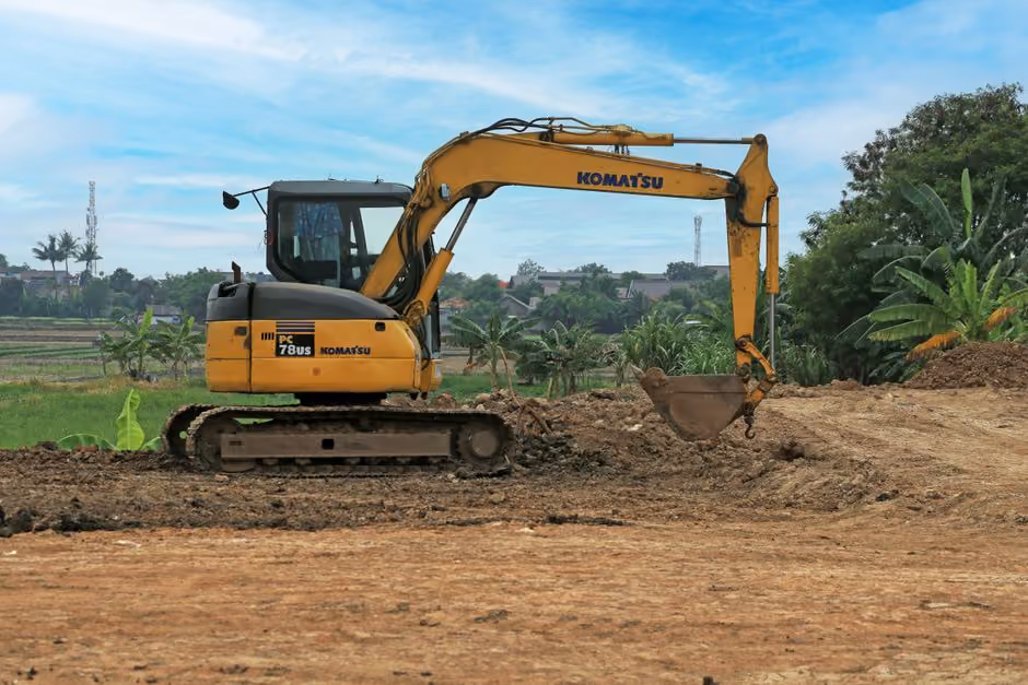 Professional post hole digging equipment tackling rocky Manchester terrain