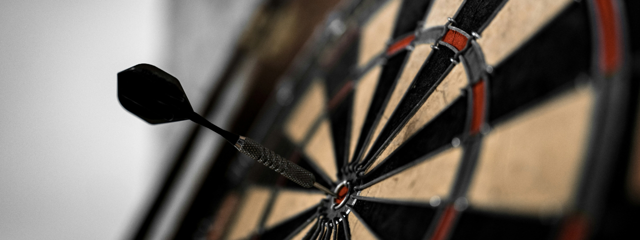 Dart hitting bullseye on a dartboard, symbolizing focus on one high-converting page instead of a full store.