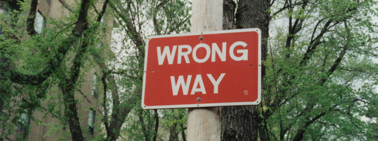 Red road sign reading “Wrong Way”, representing common CRO pitfalls in e-commerce.