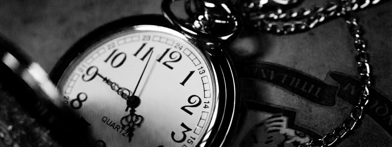 Close-up of a vintage pocket watch with a chain.
