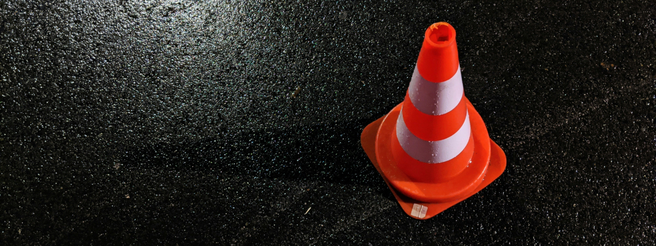 Orange traffic cone on asphalt representing Shopify SEO pitfalls to avoid.
