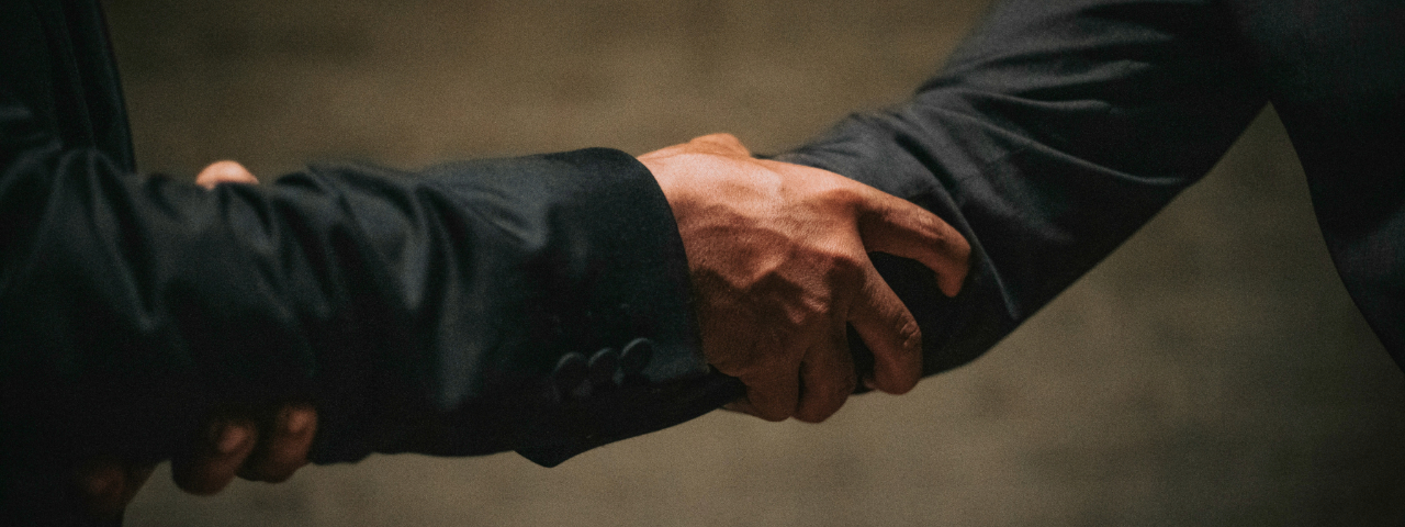 Close-up handshake, symbolizing guarantees and building customer trust on a landing page.
